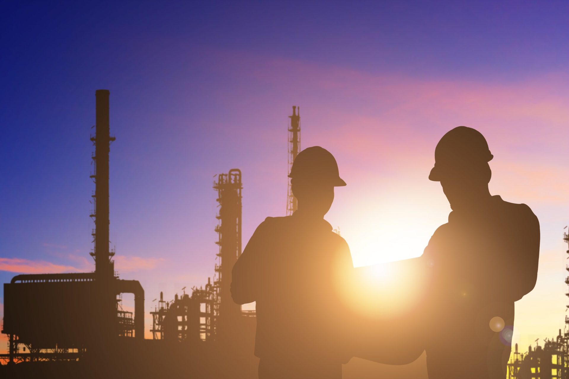 Industrial engineers reviewing work scope at high-temperature manufacturing facility
